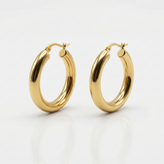 Gold hoop earrings on a light gray background