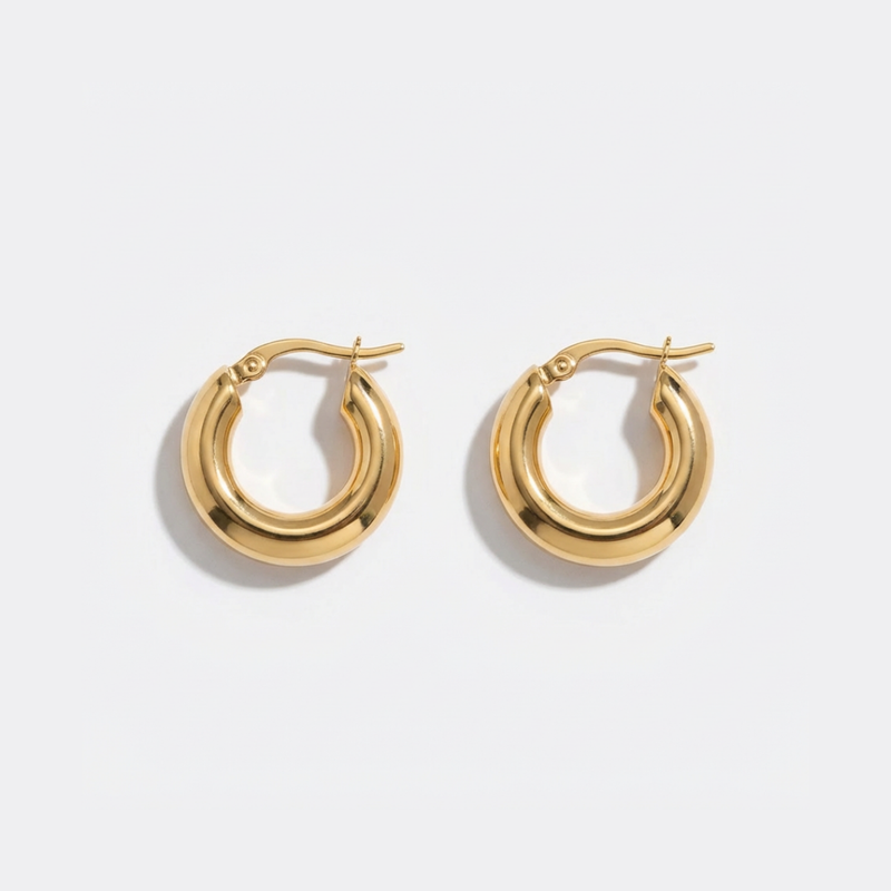 Gold hoop earrings on a light gray background