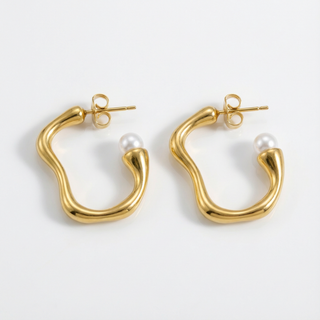 Gold hoop earrings with pearl centers on a white background