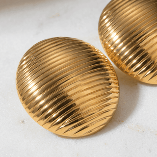 Della Dome Stud Earrings on a white background, angled view
