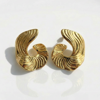 Pair of gold spiral earrings on a white background