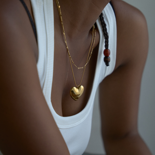 Amara Puffy Heart Pendant Necklace in gold, worn on model, close-up on the puffy heart pendant