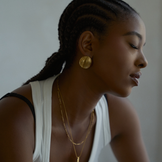 Della Dome Stud Earrings worn on model, close-up on the ear