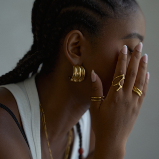 Mira Ribbed Dome Hoop Earrings in gold, worn on model, side profile
