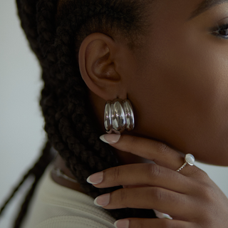 Mira Ribbed Dome Hoop Earrings in silver, worn on model, side profile close-up